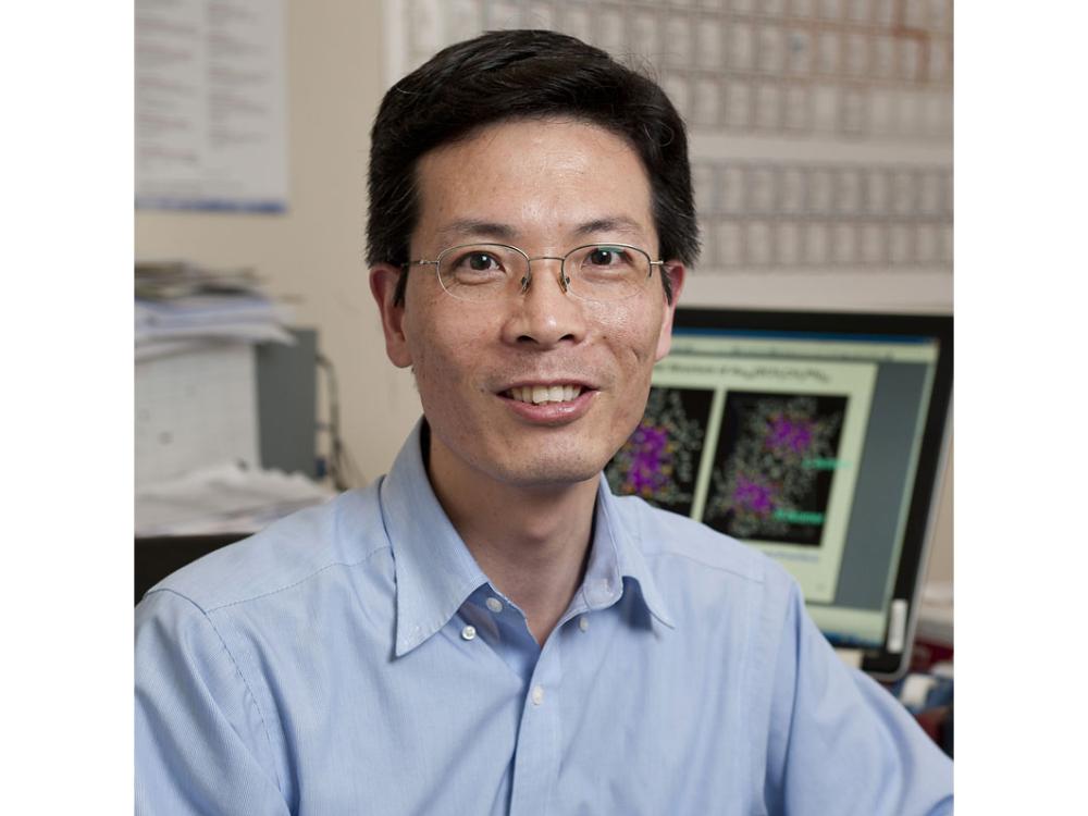 Ronchao Jin sits at desk