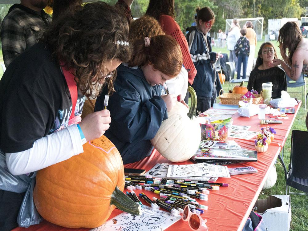 children at a table decorating pumpkins at the 2025 fall festival
