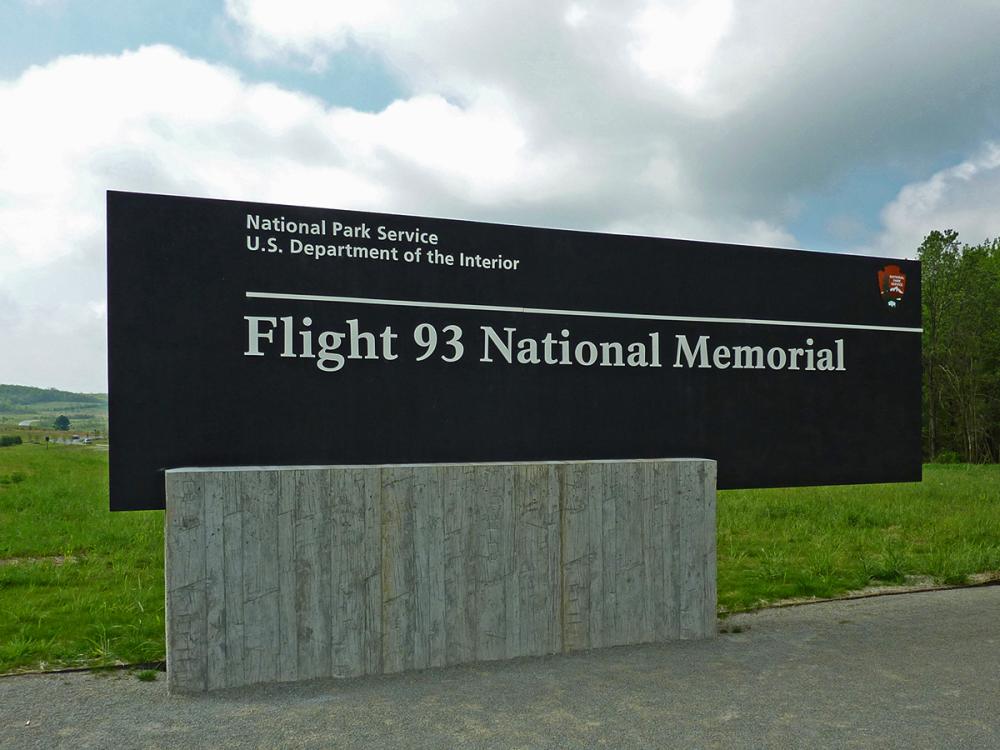 Sign for the Flight 93 National Memorial by the National Park Service, set against a grassy landscape.