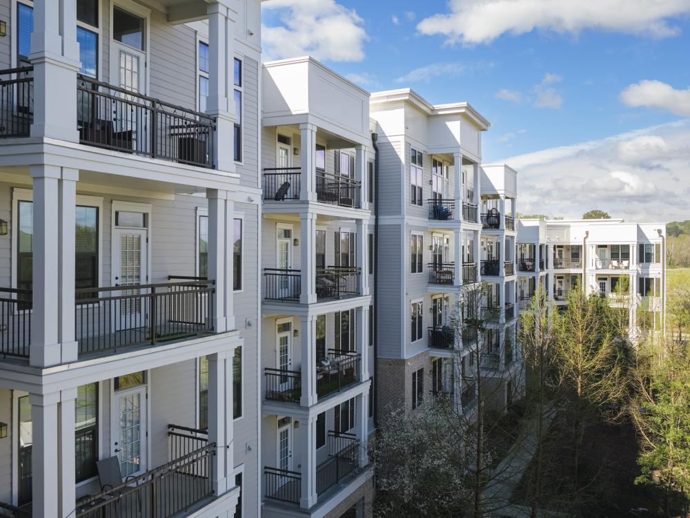 Apartment building balconies pictured on a sunny day