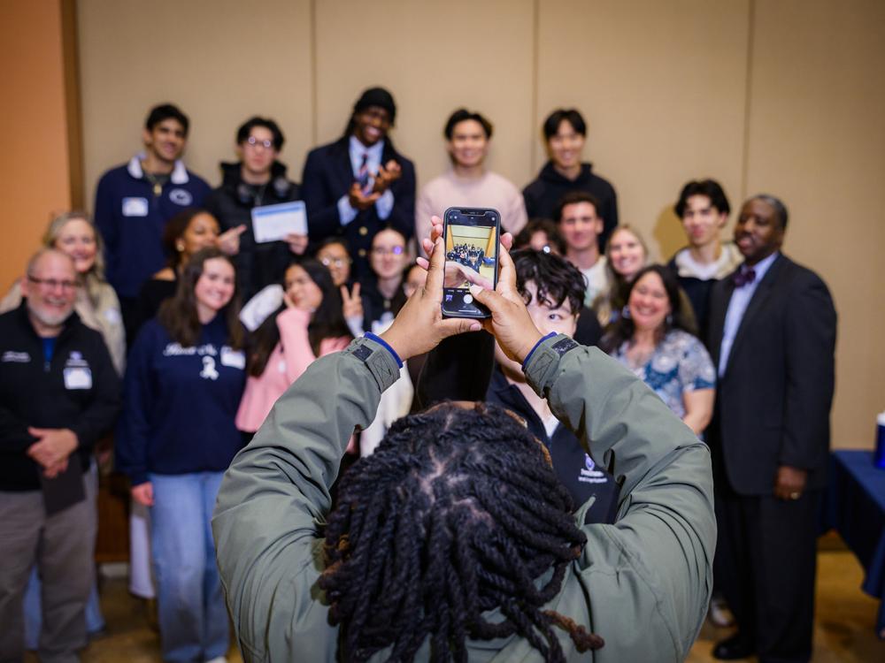 Photo of someone taking a group photo on a phone