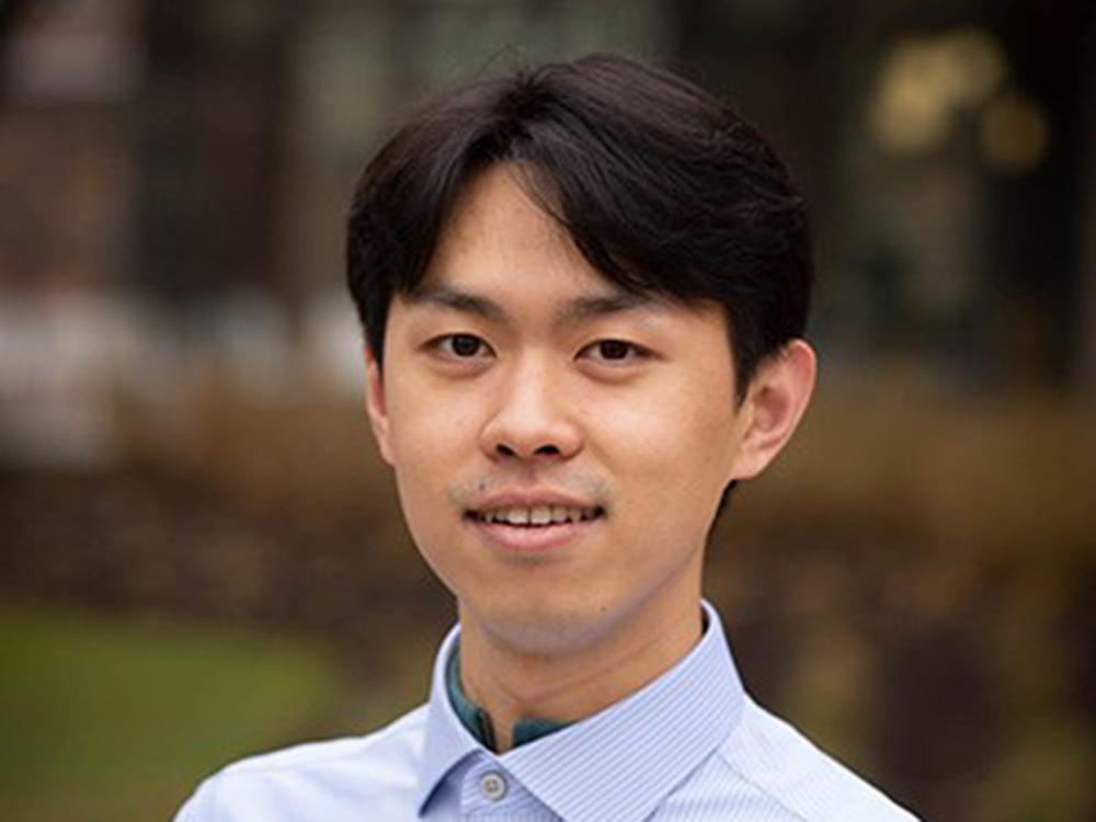 Jingzhou Wang, a twenty-something asian man with dark hair wearing a collared shirt