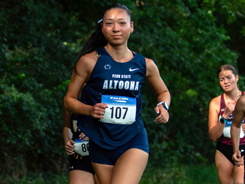 Kira Bantell runs in a Penn State Altoona uniform during a cross-country race.