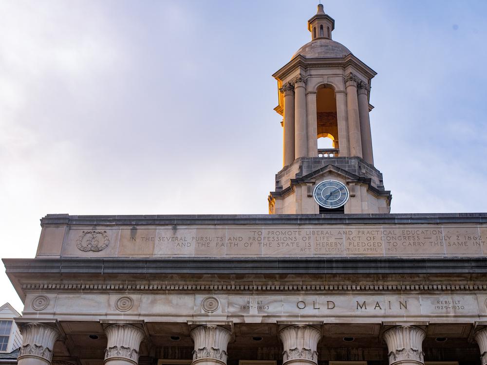 An image of Old Main's bell tower and the words Old Main engraved in stone