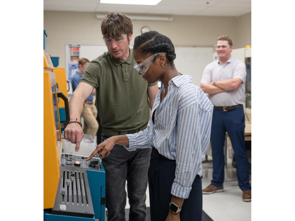 An instructor teaches a student in a polymer lab