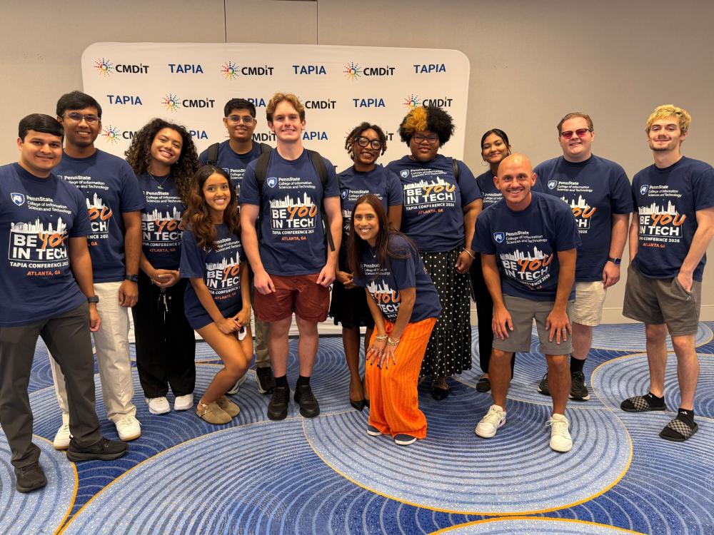 group of college students wearing matching t-shirts at a conference