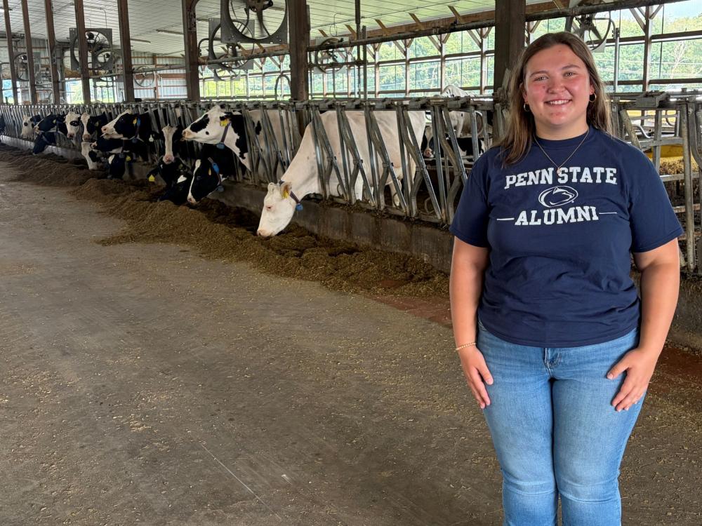Hannah Mansfield posing with dairy cows.