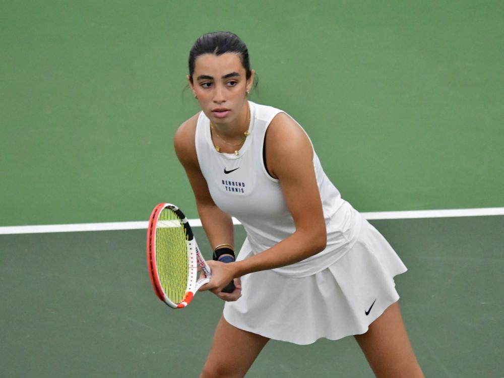 A member of the Penn State Behrend women's tennis team prepares to return a serve.