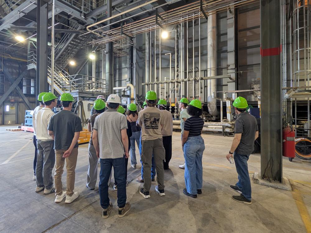 REU students standing inside a power plant
