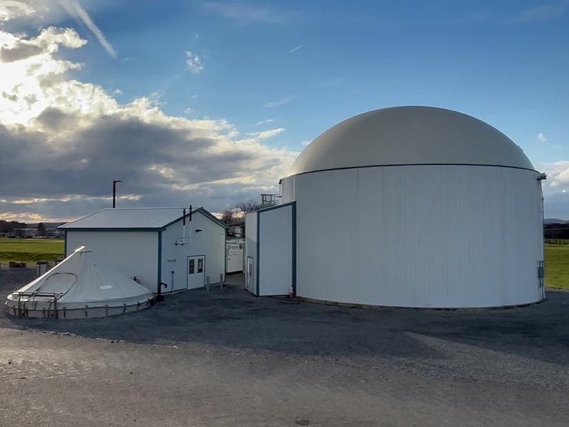 Large white buildings housing an anaerobic digester. 