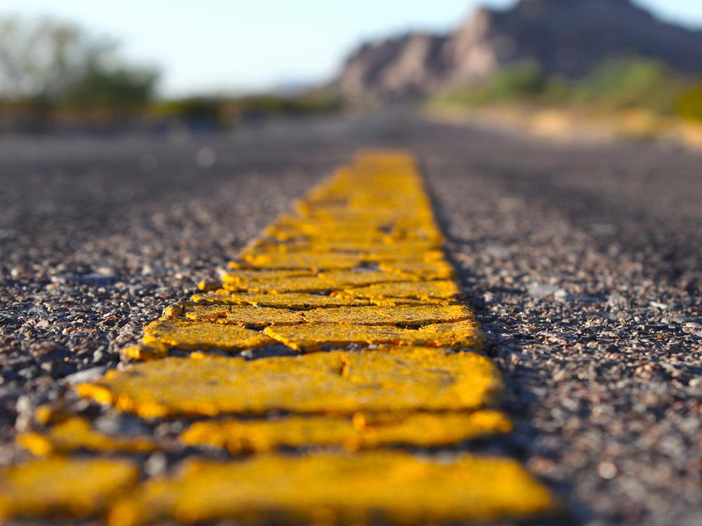 close up of yellow painted line on road