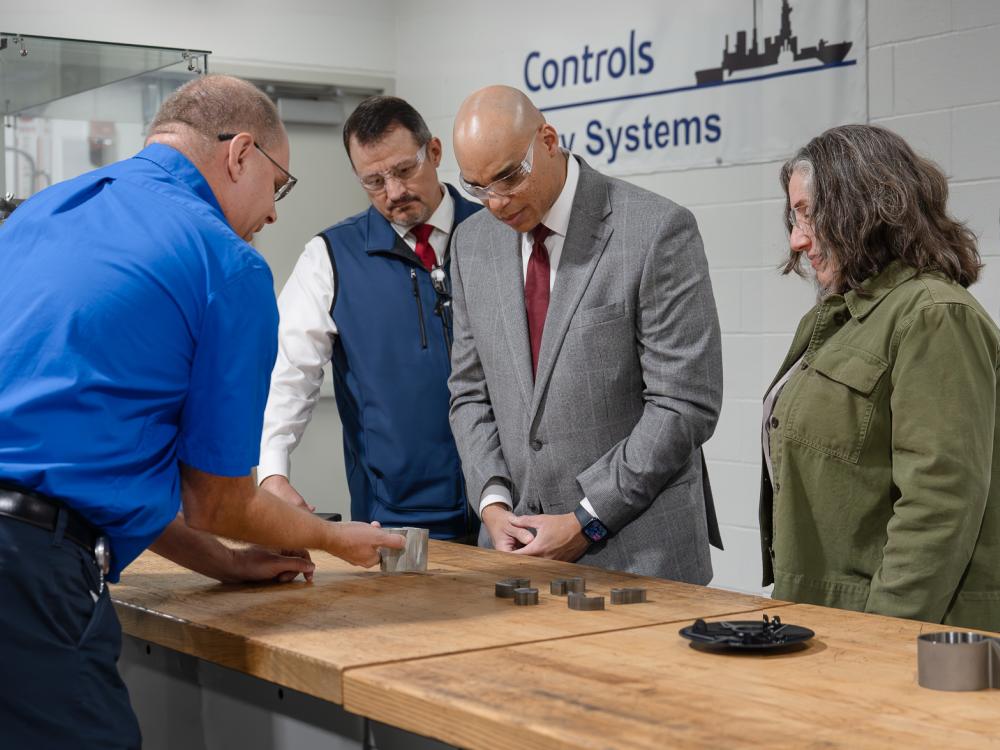 A group of people tour a technologies facility