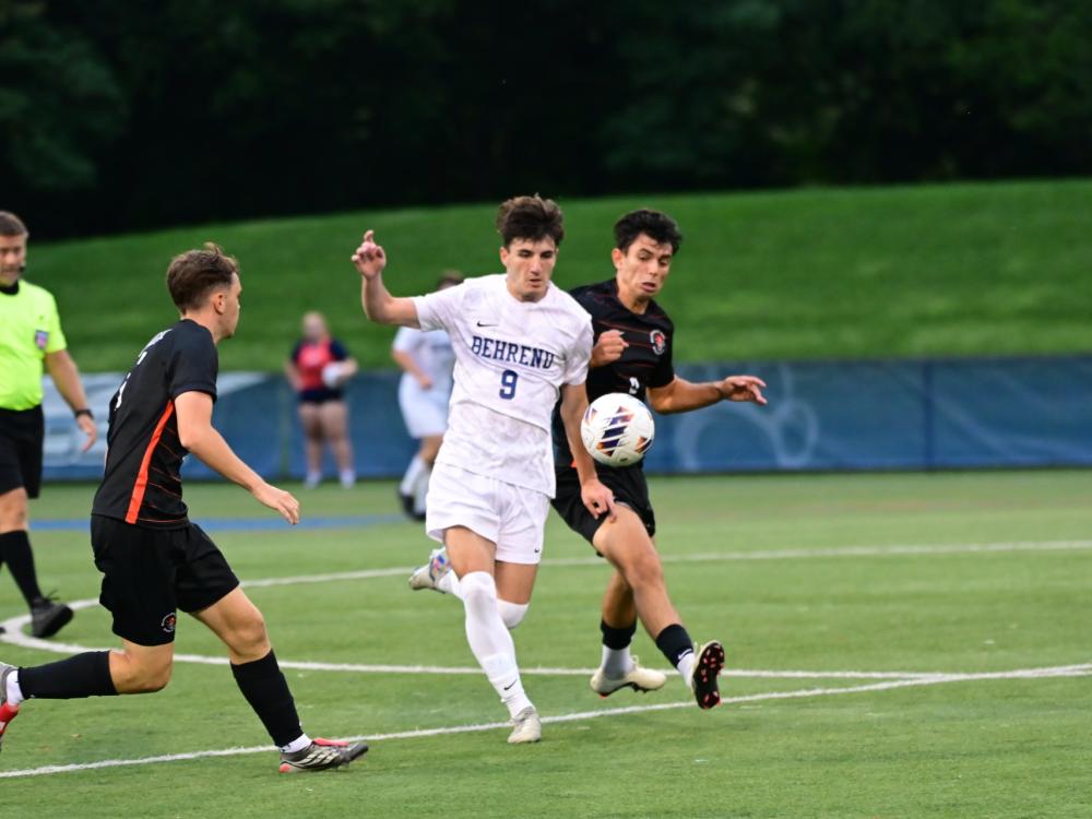 Penn State Behrend soccer player Daniel Christafano advances the ball downfield.
