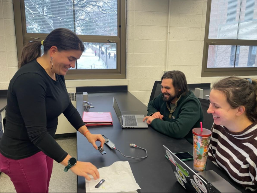Verónica Román-Reyna teaching students Tony Vozzella and Lauren Hendricks