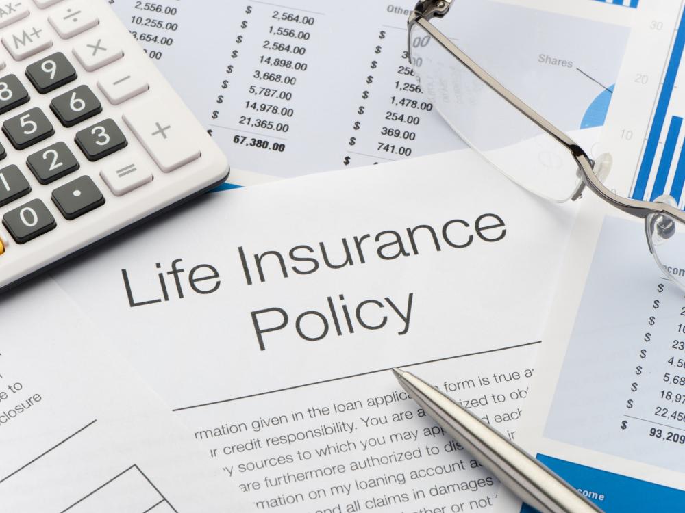 Close up of Life Insurance Policy with pen, calculator