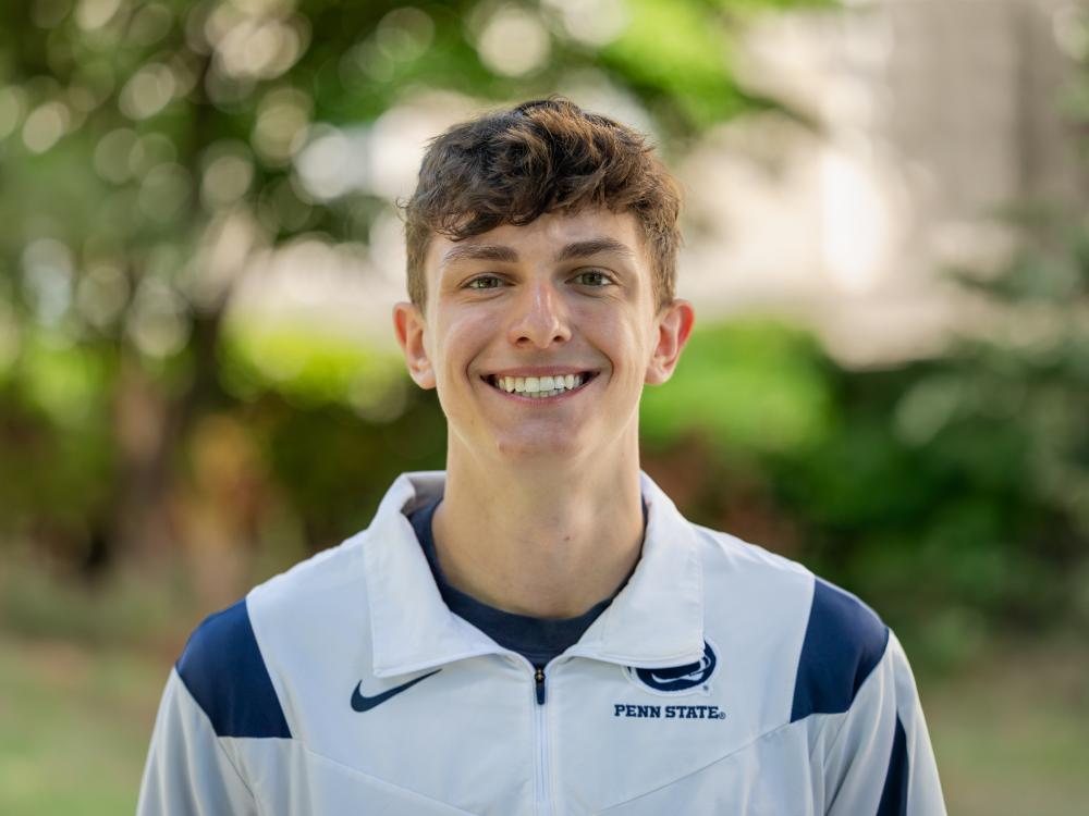 Jansen Hoffard wears a Penn State jacket outdoors.