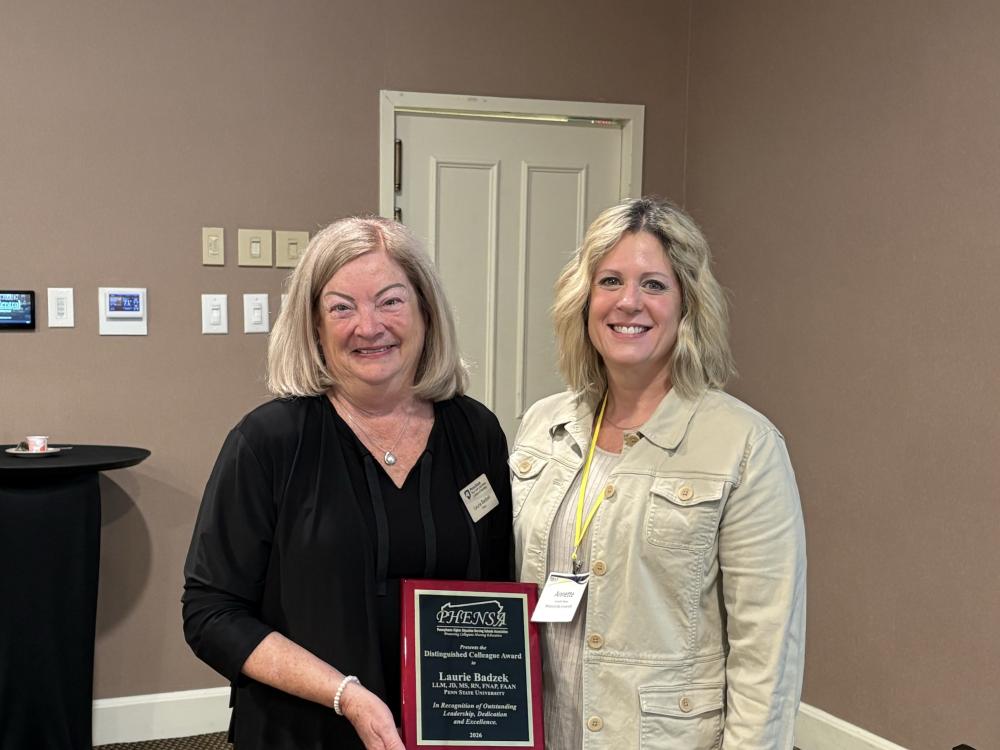 Nese College of Nursing Dean Laurie Badzek, left, receives award from Annette Weiss, current president of PHENSA