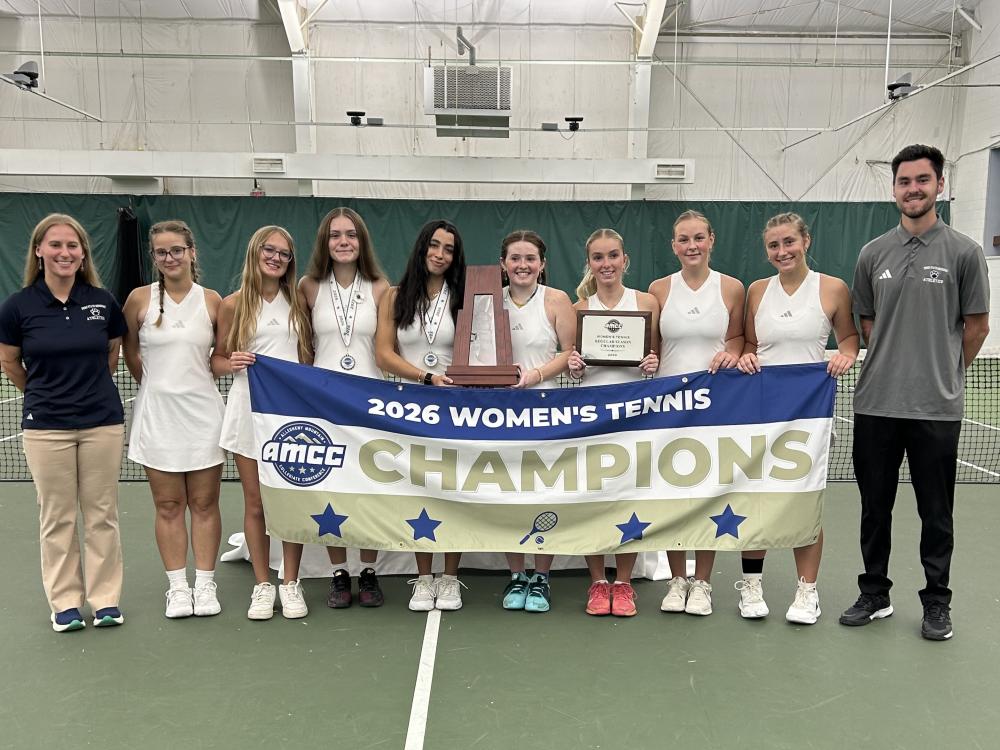 The Penn State Behrend women's tennis team poses with the AMCC championship banner.