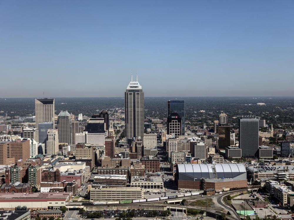 A few very tall buildings in the middle distance with shorter city buildings surrounding
