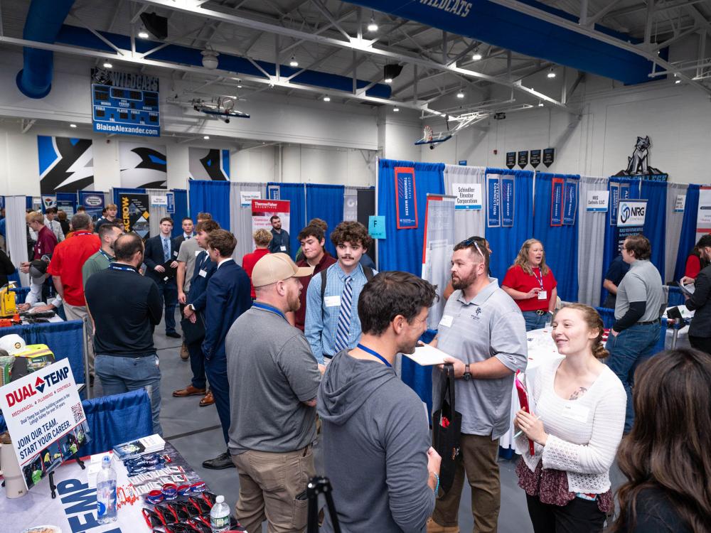 Students and employees interact at a career fair. 