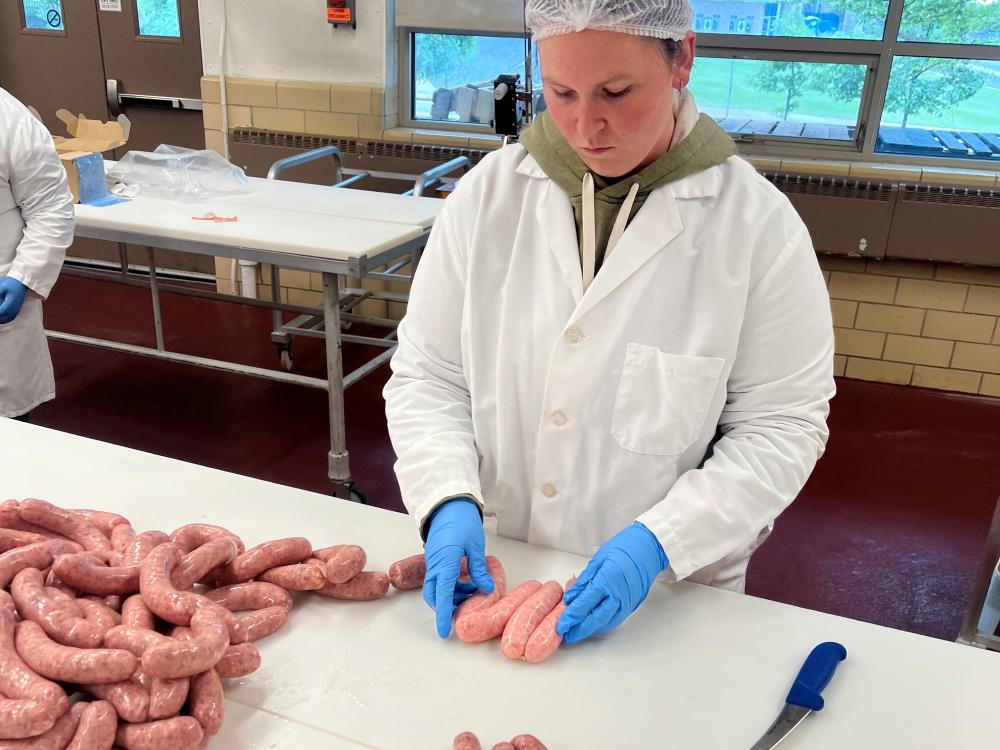 Rebekah Miller processing meat.