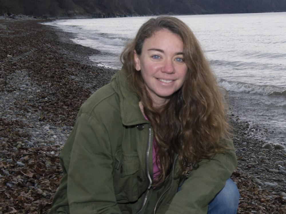 Photo of Sherri "Sam" Mason in front of a lake