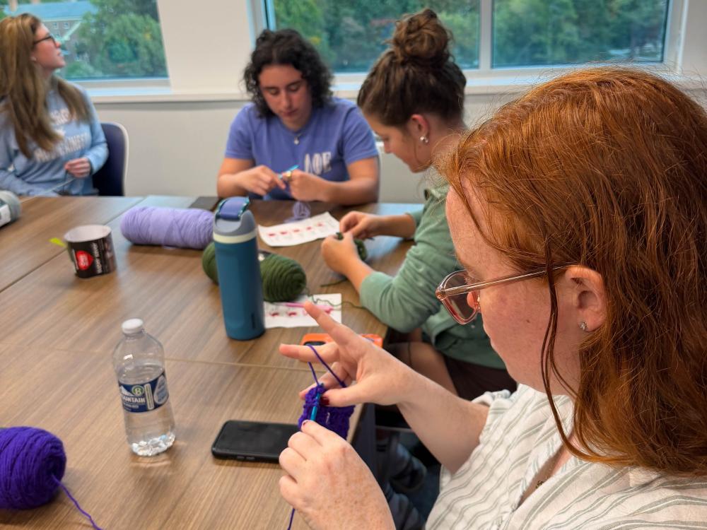 Students work on a crochet project during a workshop.