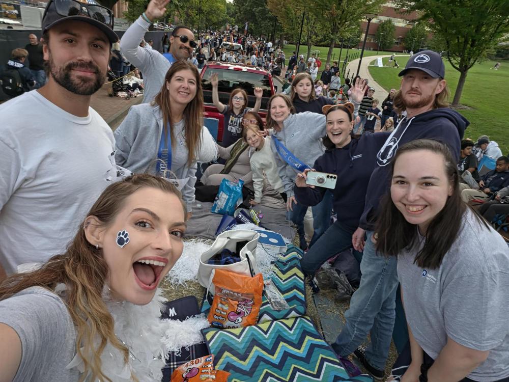 A group of people take a selfie on a parade float.