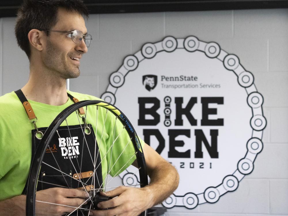 Bike Den staff holding a bike wheel 
