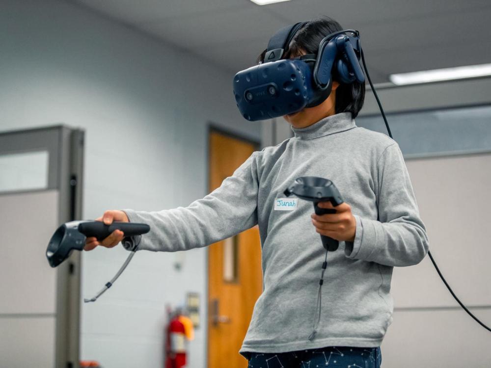 A woman uses virtual reality equipment