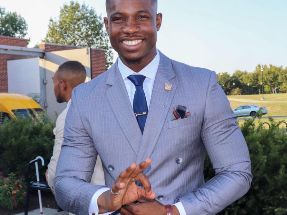 Clinton Asalu in a suit and tie