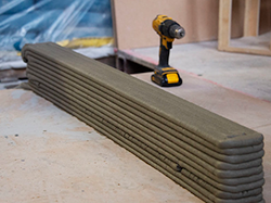 Ten layers of wet, grey concrete sit on the floor