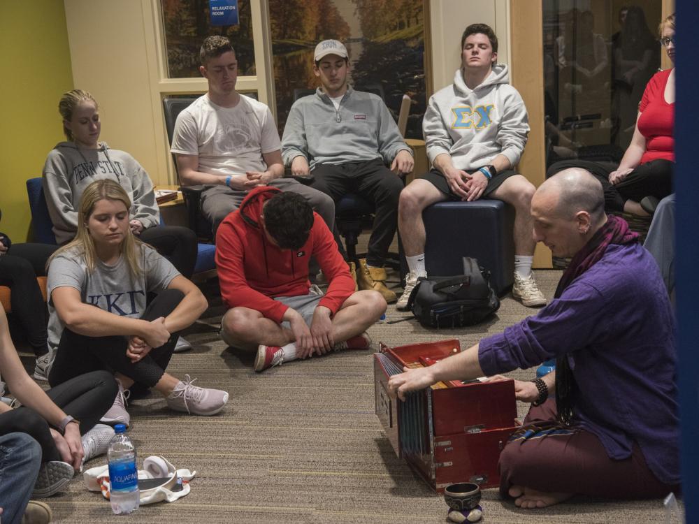 Mark Agrusti of the Dharma Lions guides students through a mindful meditation session the Wellness Suite