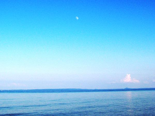 The moon shining over a body of water