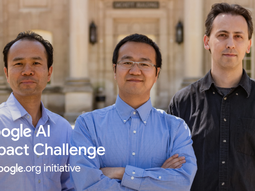 Three researchers standing in front of a building