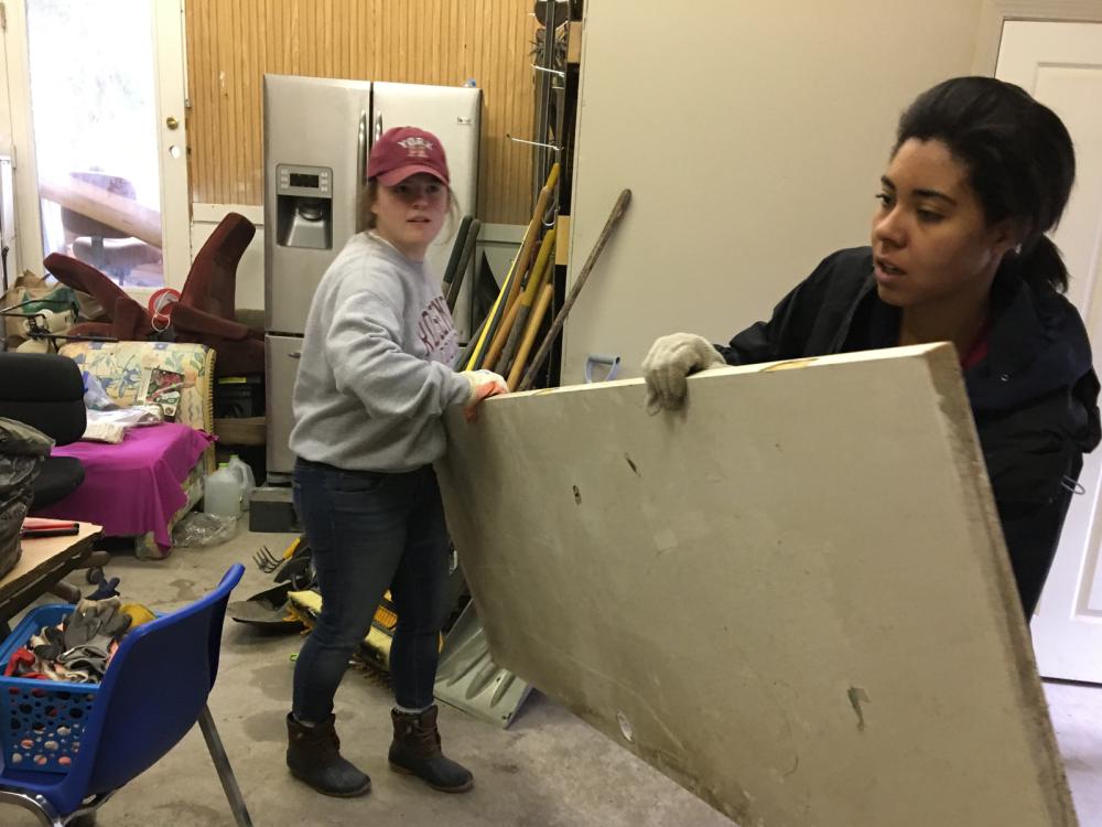 Penn State students move building materials during an alternative break trip