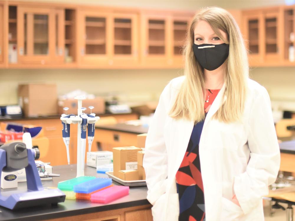 A portrait of Ashley Russell, assistant professor of biochemistry and molecular biology, in a lab at Penn State Behrend