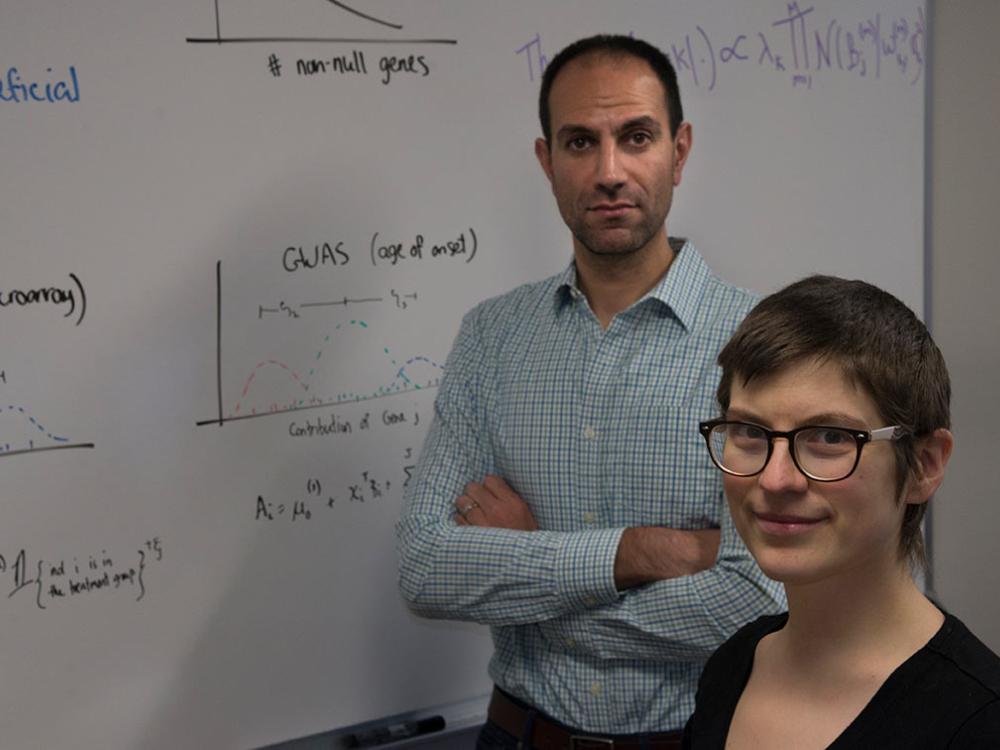 Ben Shaby and Daisy Philtron in front of whiteboard with equations