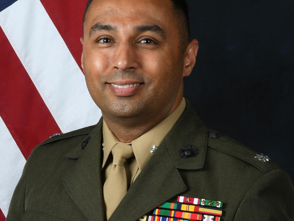 Headshot photo of Lt. Col. Tom Chhabra in Marine Corps uniform with the American flag in the background.