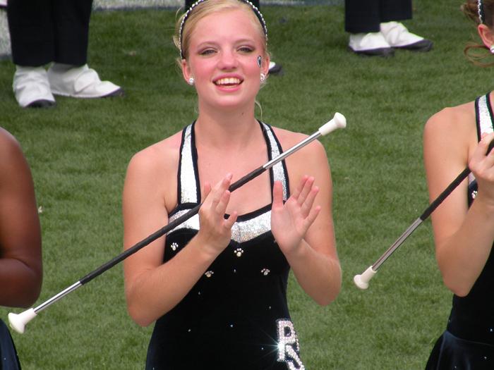 Jennifer Chelko, a Blue Band majorette, spinning a baton while in full dress.