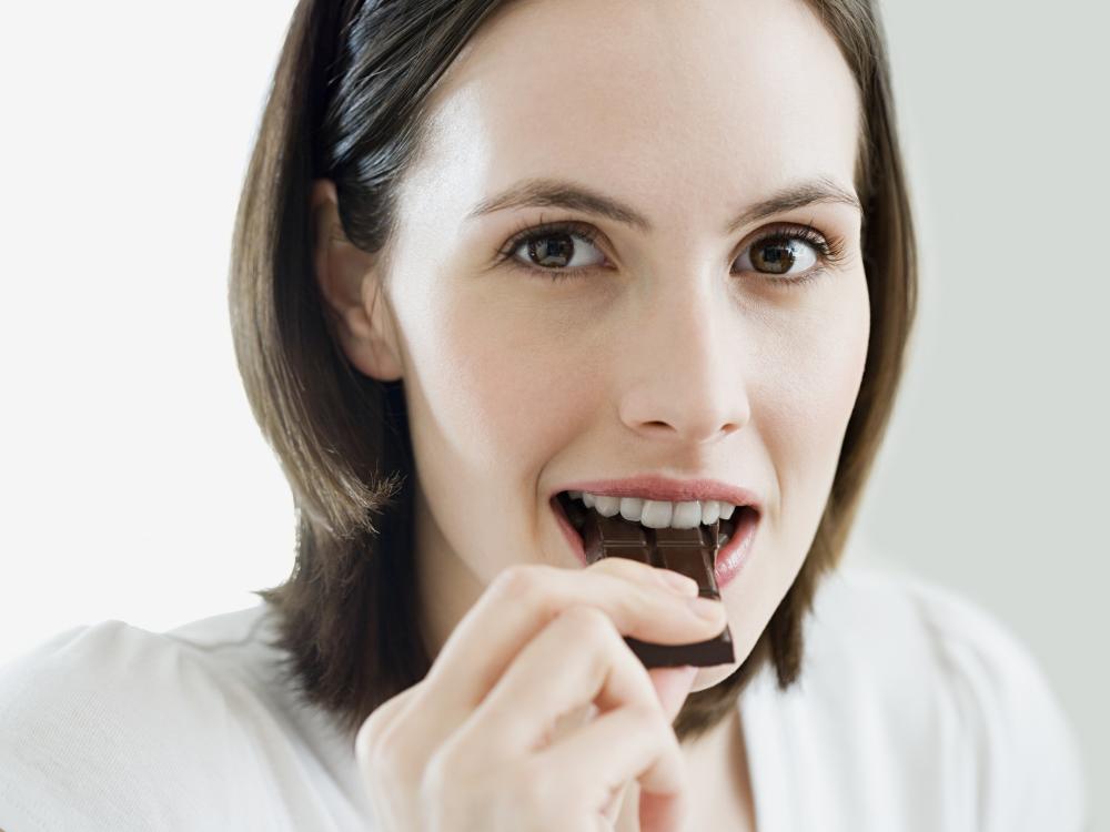 woman eating chocolate bar