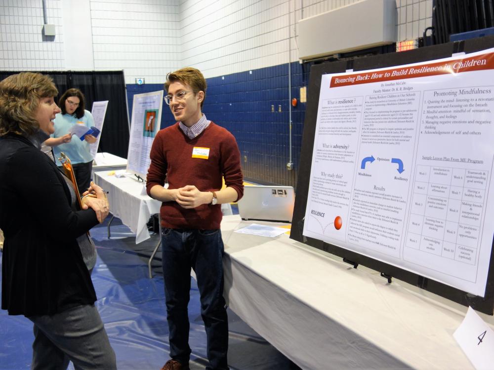 Jonathan McCabe, senior psychology student, presents his research poster at the 2018 Research and Creative Exposition