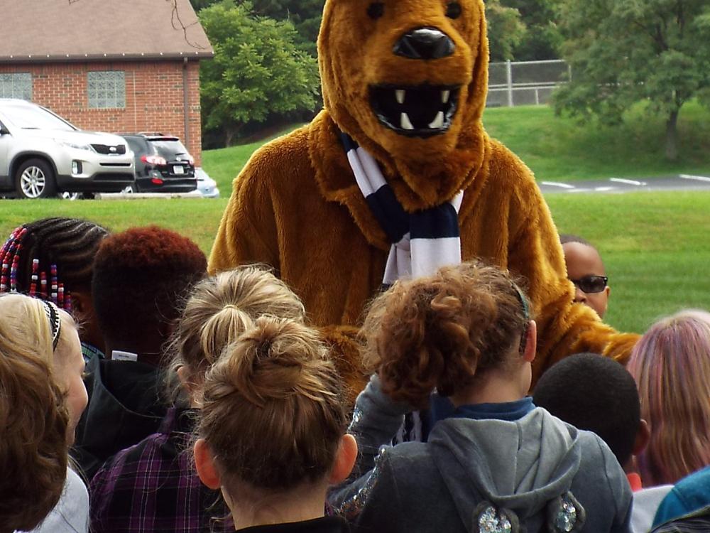 lioin mascot with kids