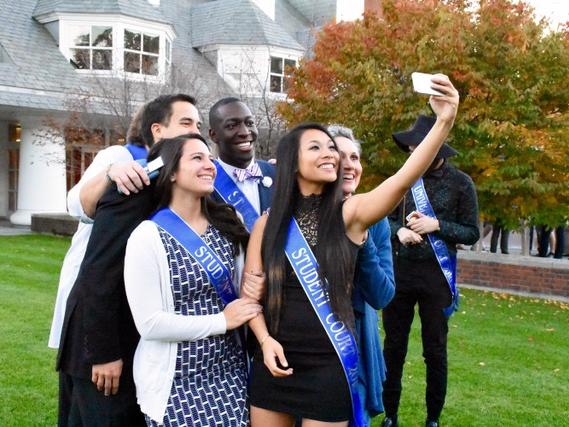 Student Homecoming Court students pose together for a selfie