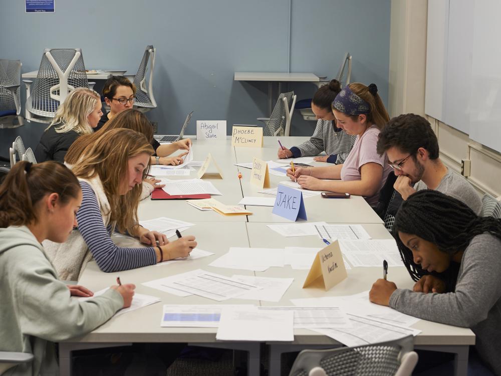 Students all working together on an assignment at large table