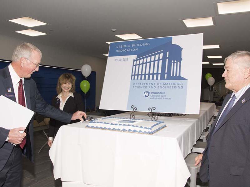 William Easterling, dean of the College of Earth and Mineral Sciences, left, cuts the cake as Susan Sinnott, head of the Materials Science and Engineering Department, and Eric Barron, University President, look on.