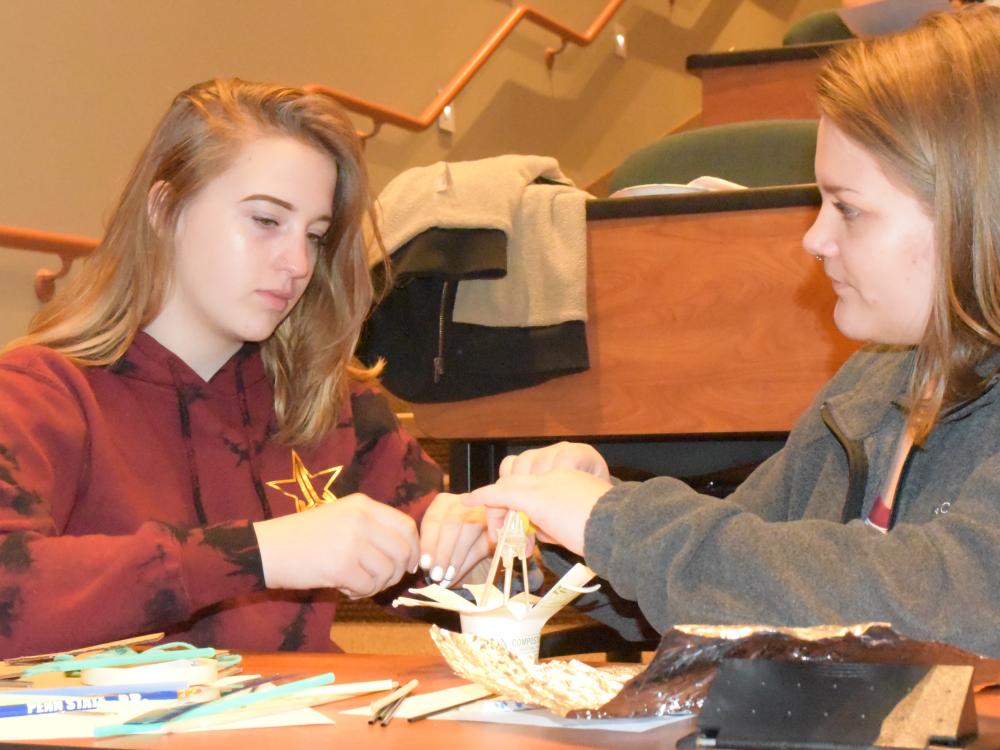 Ani Entrekin, left, and Maygan Stoddard work to create a dome during the Inspiring Bright Futures program, held May 22 at Penn State Behrend.