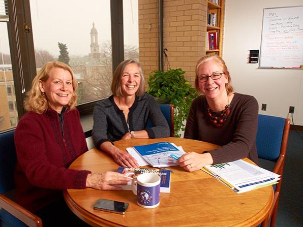 three women researchers sitting around a table