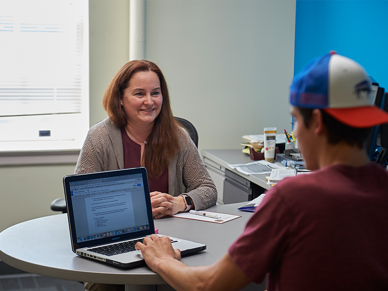 Adviser helping student in an office