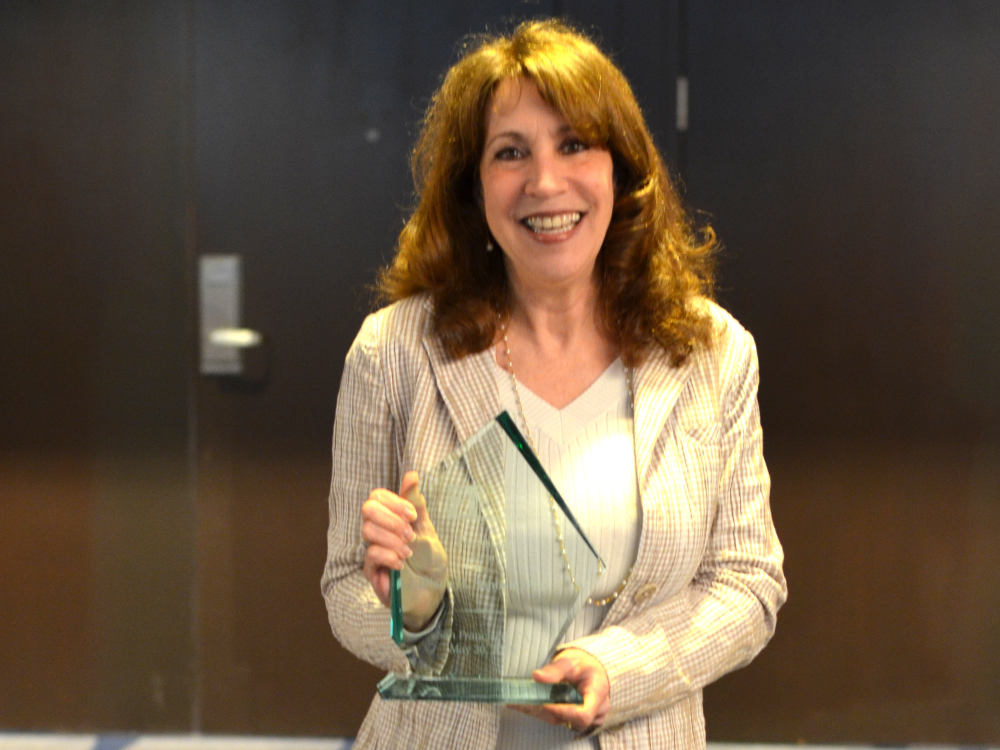 woman holding glass trophy